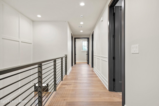 hall with light hardwood / wood-style floors