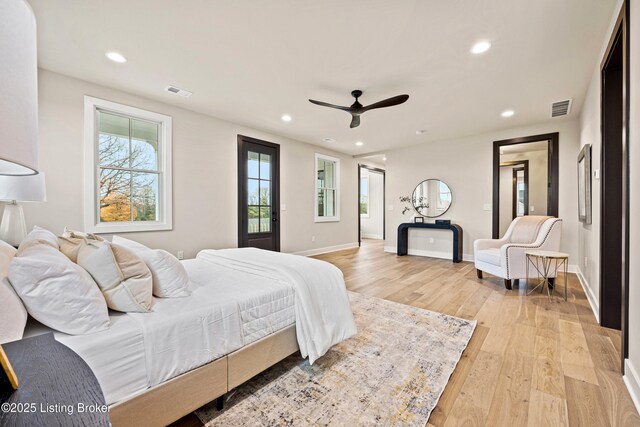 bedroom with ceiling fan and light hardwood / wood-style flooring