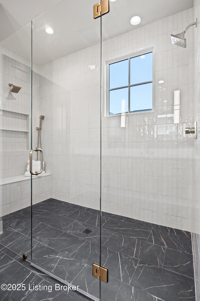 bathroom featuring a shower with door