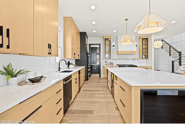 kitchen with light brown cabinetry, beverage cooler, and a center island