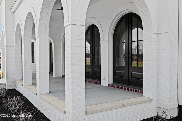 doorway to property with brick siding and french doors