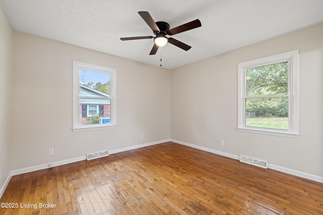 spare room with hardwood / wood-style flooring and ceiling fan