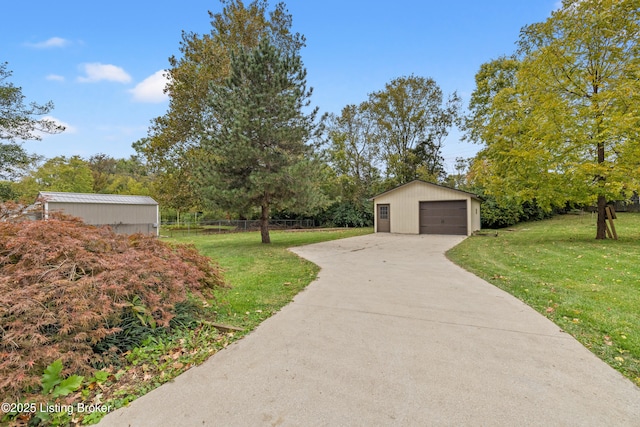 view of yard featuring a garage and an outdoor structure