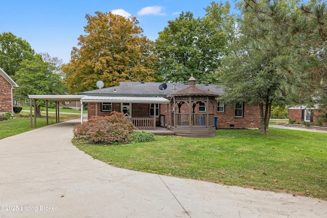 view of front of house with a front lawn, a carport, and covered porch