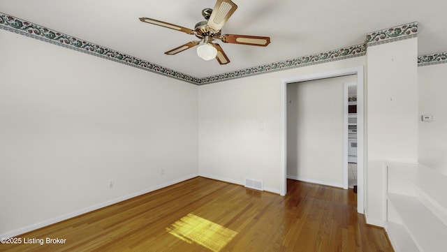 unfurnished room with wood-type flooring and ceiling fan