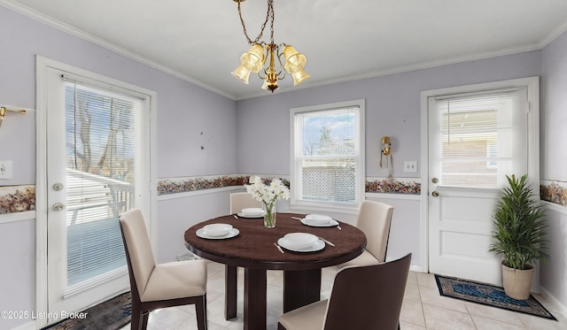 dining space with an inviting chandelier, ornamental molding, and light tile patterned flooring