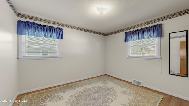 unfurnished room featuring wood-type flooring