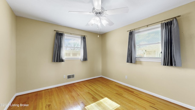 spare room featuring wood-type flooring and ceiling fan