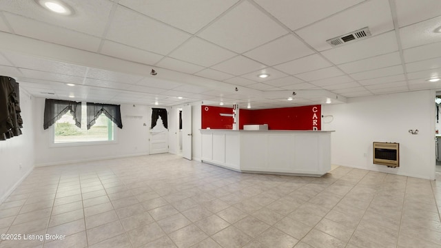 interior space with indoor bar, heating unit, and a drop ceiling