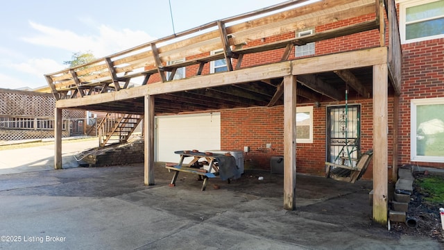 view of patio with a wooden deck and a garage