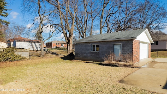 exterior space featuring an outbuilding, a yard, and a garage