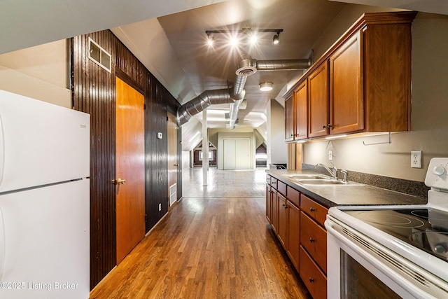 kitchen with white appliances, dark hardwood / wood-style flooring, and sink