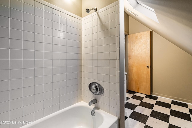 bathroom with a skylight and shower / bathtub combination