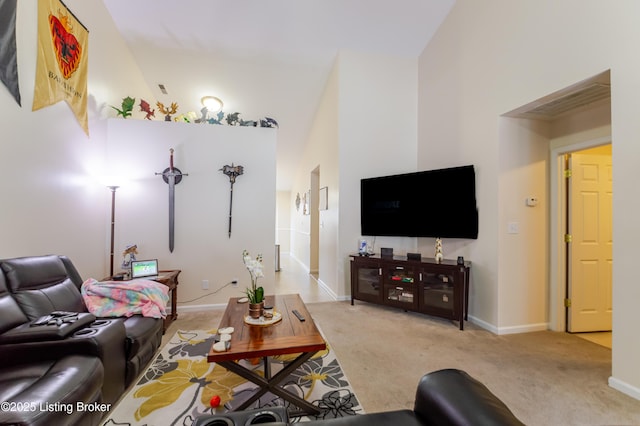 living room with high vaulted ceiling and light colored carpet