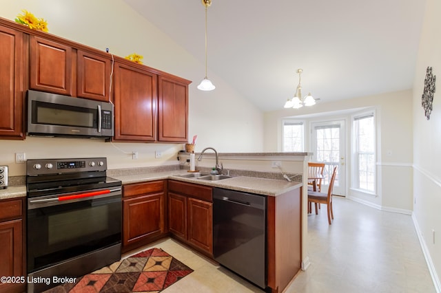 kitchen with pendant lighting, stainless steel appliances, kitchen peninsula, and sink