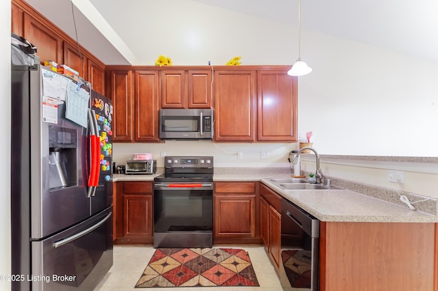 kitchen with pendant lighting, stainless steel appliances, vaulted ceiling, and sink