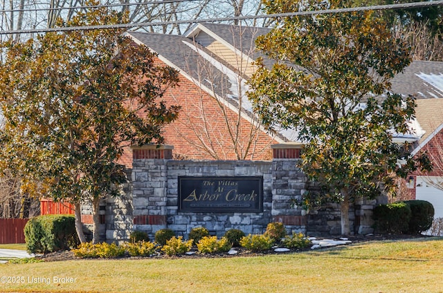 community / neighborhood sign with a lawn