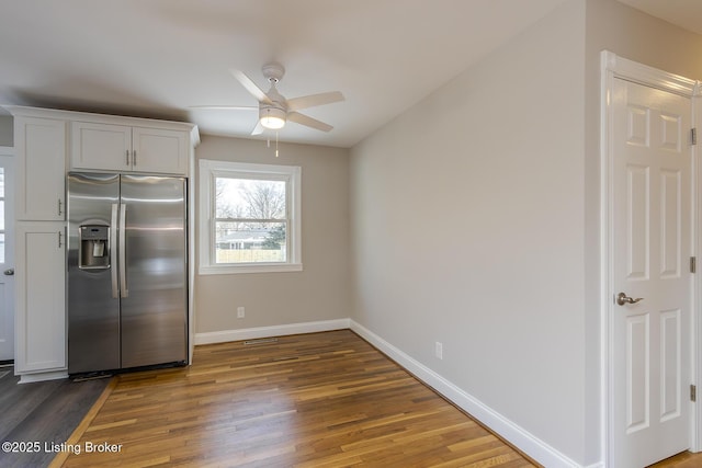 kitchen featuring dark hardwood / wood-style flooring, ceiling fan, white cabinets, and stainless steel refrigerator with ice dispenser