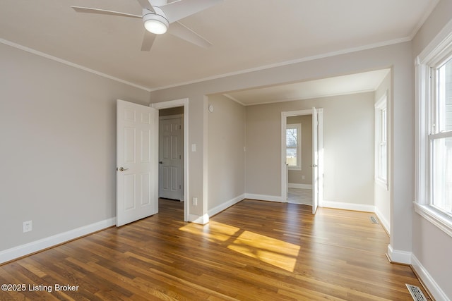 empty room with ceiling fan, ornamental molding, and hardwood / wood-style floors