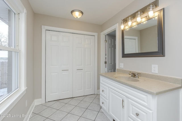 bathroom with tile patterned floors, vanity, and a wealth of natural light