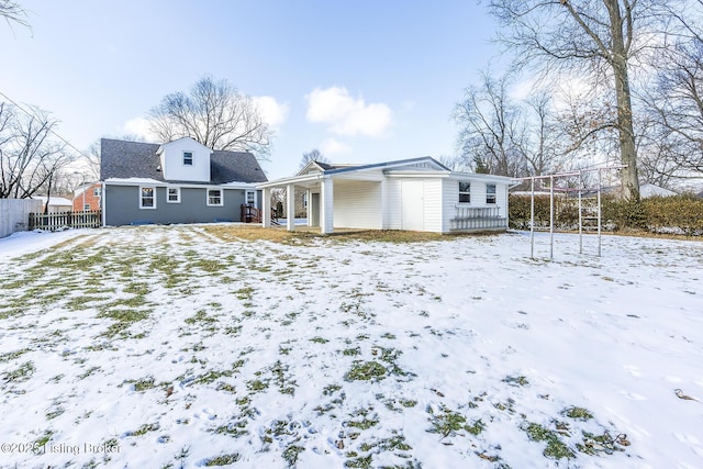 view of snow covered back of property