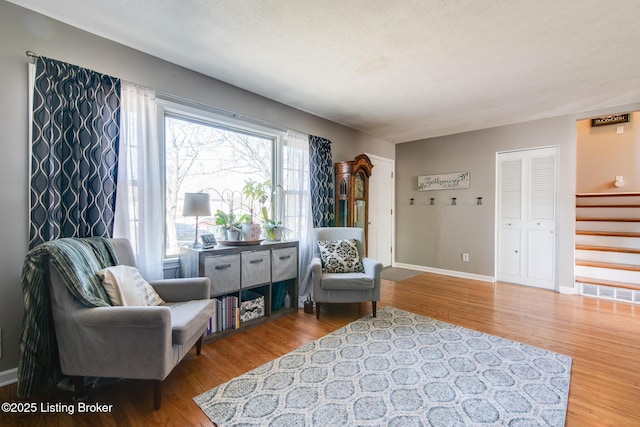 living area featuring hardwood / wood-style floors and a textured ceiling