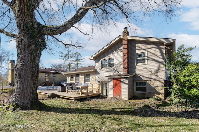 rear view of house with a yard and a deck