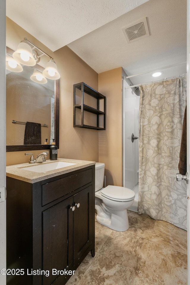 bathroom featuring vanity, toilet, a textured ceiling, and a shower with curtain