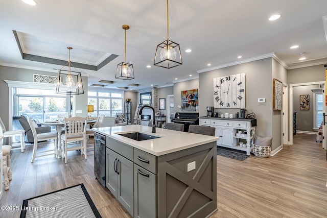 kitchen with dishwashing machine, sink, gray cabinetry, a center island with sink, and decorative light fixtures