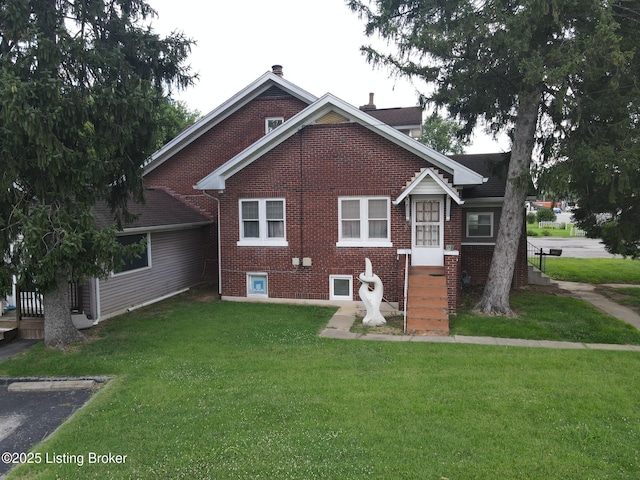 rear view of property featuring a lawn