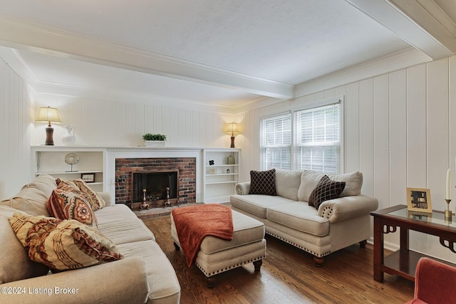 living room with beamed ceiling, ornamental molding, dark hardwood / wood-style flooring, and a brick fireplace