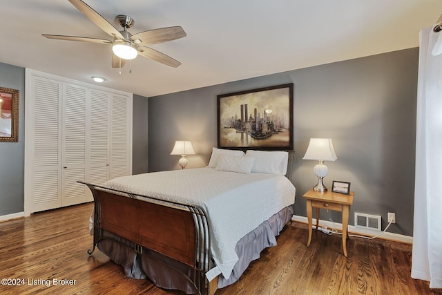 bedroom with ceiling fan, dark hardwood / wood-style floors, and a closet