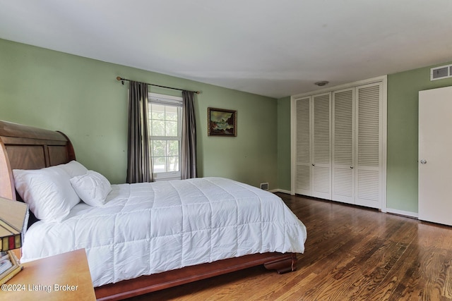 bedroom with dark hardwood / wood-style flooring