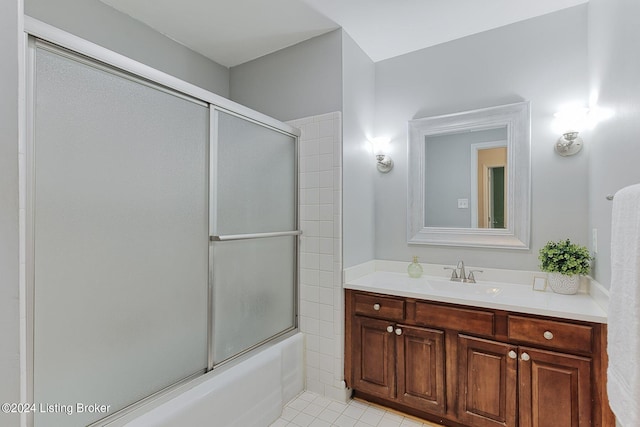 bathroom with enclosed tub / shower combo, vanity, and tile patterned floors