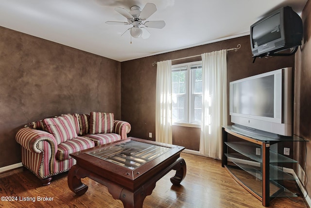 living room featuring ceiling fan and hardwood / wood-style floors