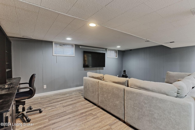 living room with wood-type flooring and wood walls