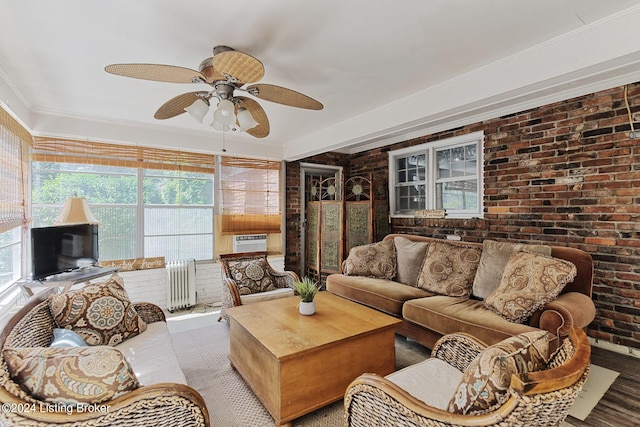 living room featuring crown molding, radiator, cooling unit, ceiling fan, and brick wall