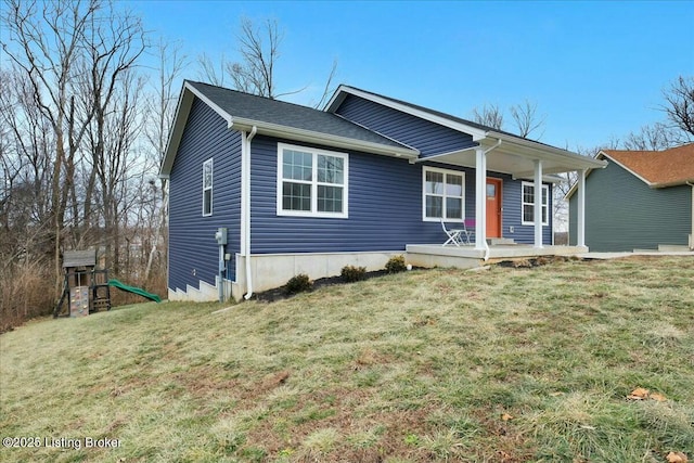 view of front of property featuring a front yard, a playground, and covered porch