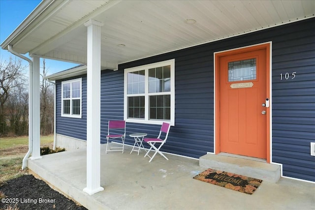 view of exterior entry featuring a porch