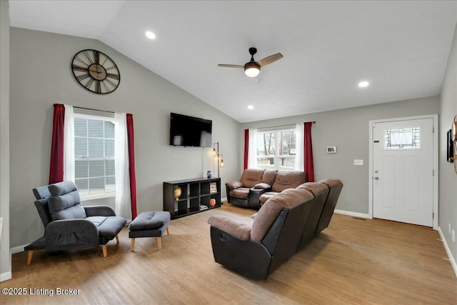 living room featuring lofted ceiling, light hardwood / wood-style flooring, and ceiling fan