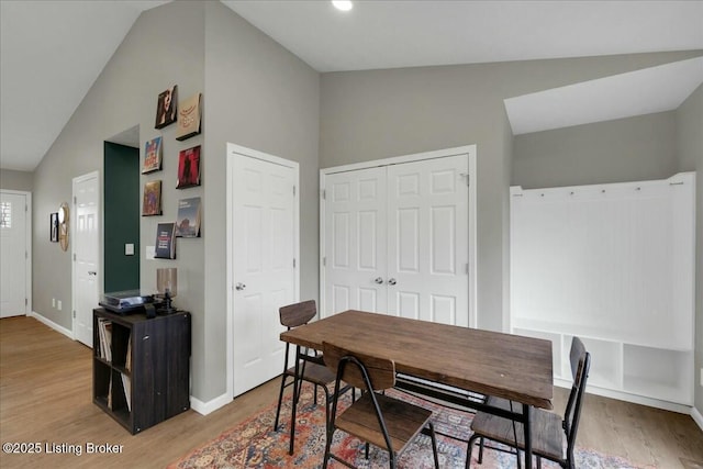 dining room with vaulted ceiling and hardwood / wood-style floors