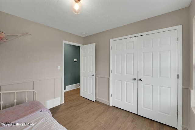 bedroom featuring a closet and light hardwood / wood-style flooring