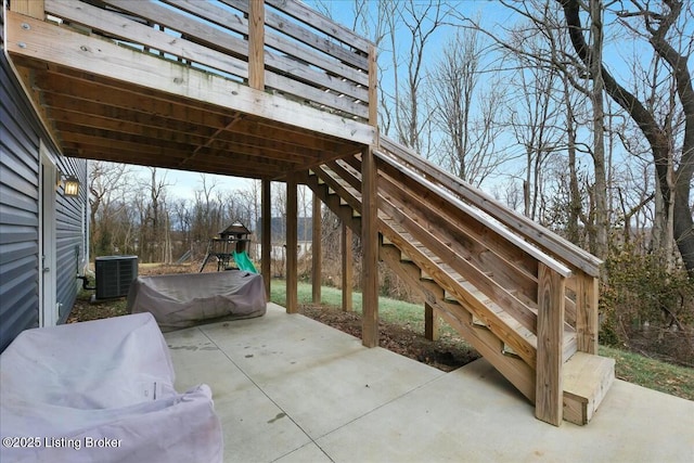 view of patio featuring central AC and a playground