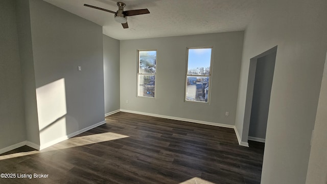 unfurnished room with a textured ceiling, dark hardwood / wood-style floors, and ceiling fan