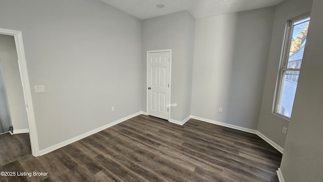 spare room featuring dark hardwood / wood-style flooring