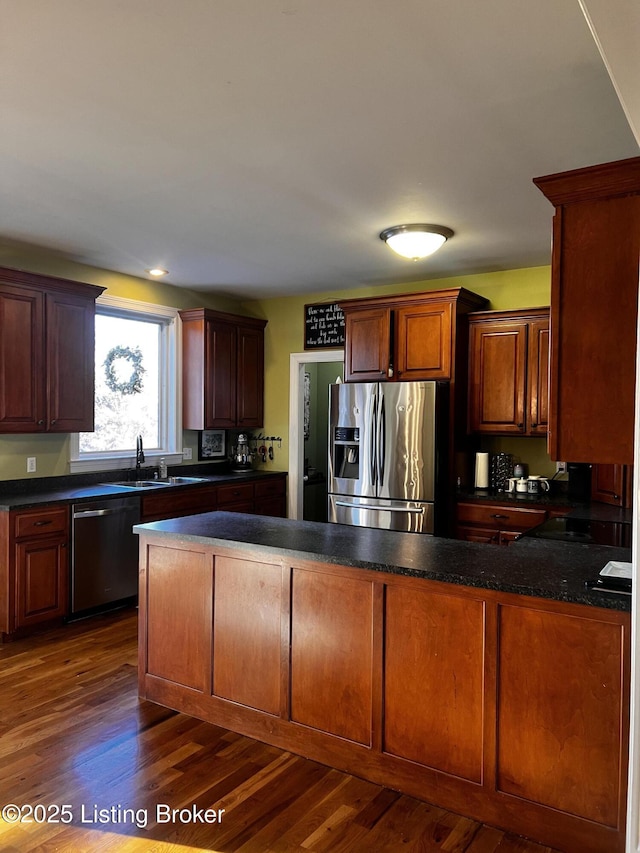 kitchen with stainless steel appliances, sink, and dark hardwood / wood-style flooring