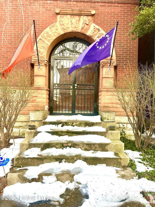 view of snow covered property entrance