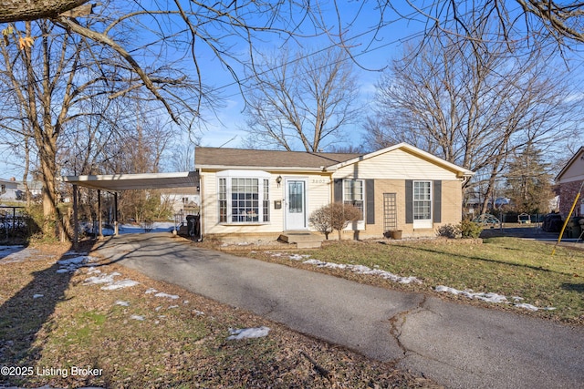 view of front facade with a carport and a front yard