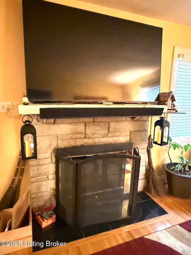 interior details with a fireplace and wood finished floors