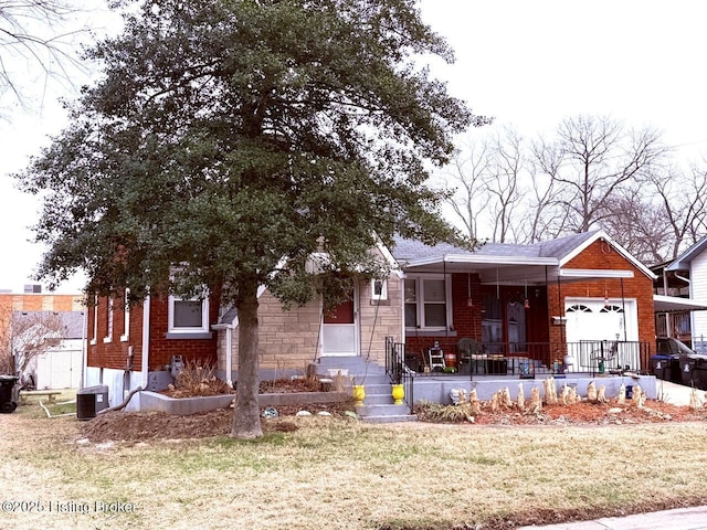 view of front of house with a porch, an attached garage, brick siding, stone siding, and a front lawn